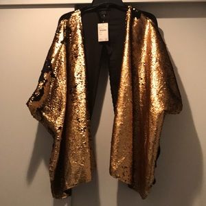 Gold sequined reversible black cape with sleeves.